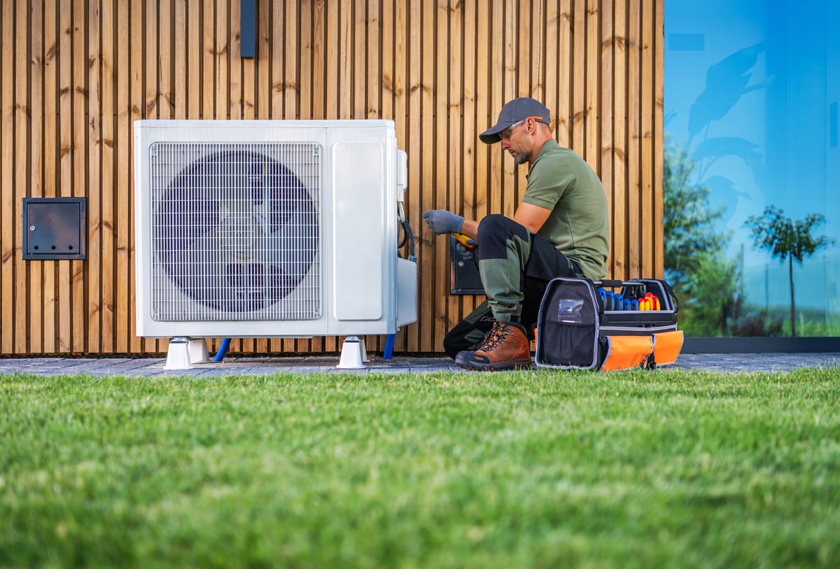 Technician servicing an air conditioning unit